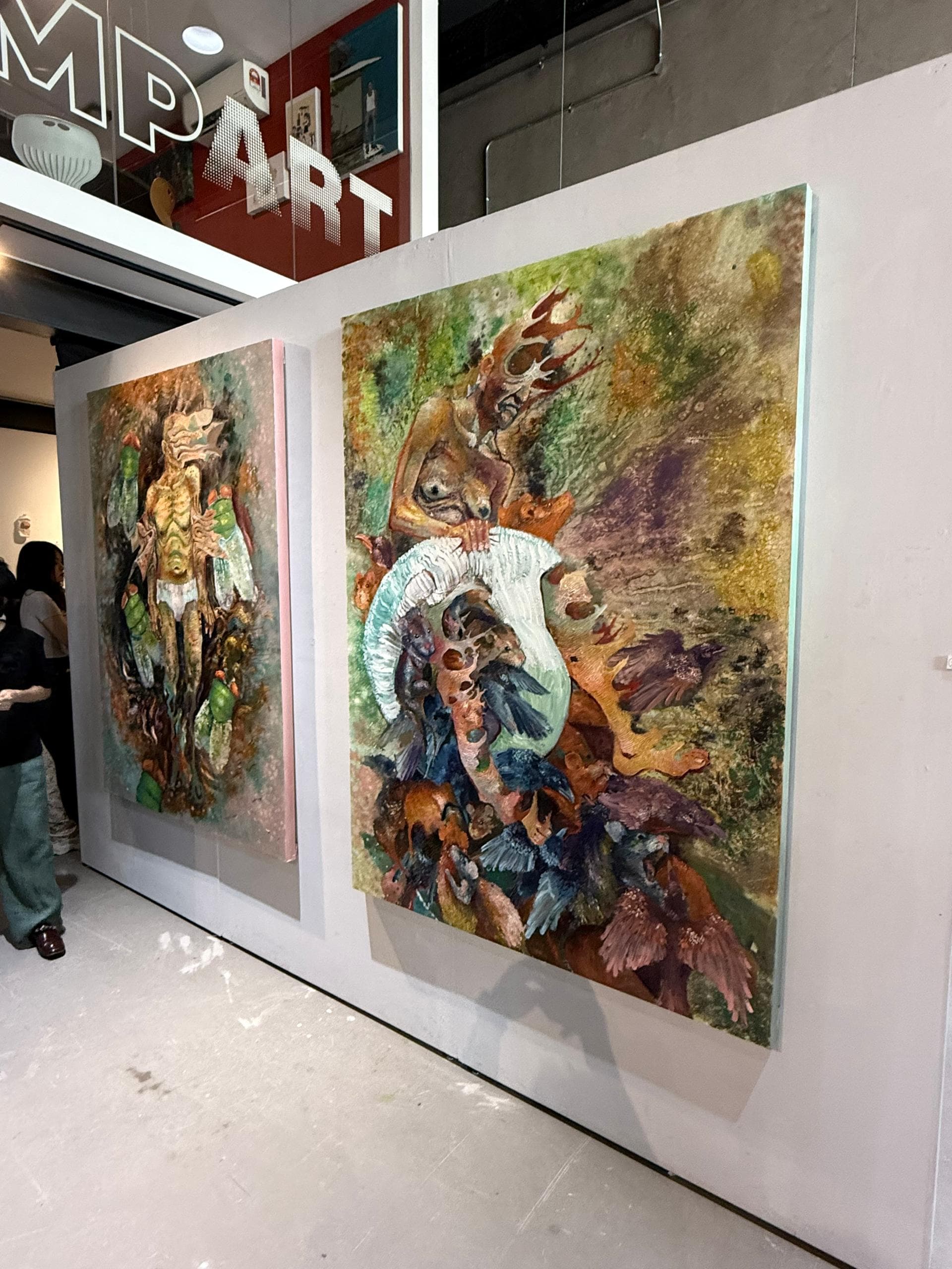 Large paintings displayed inside the Fine Art Graduation Exhibition