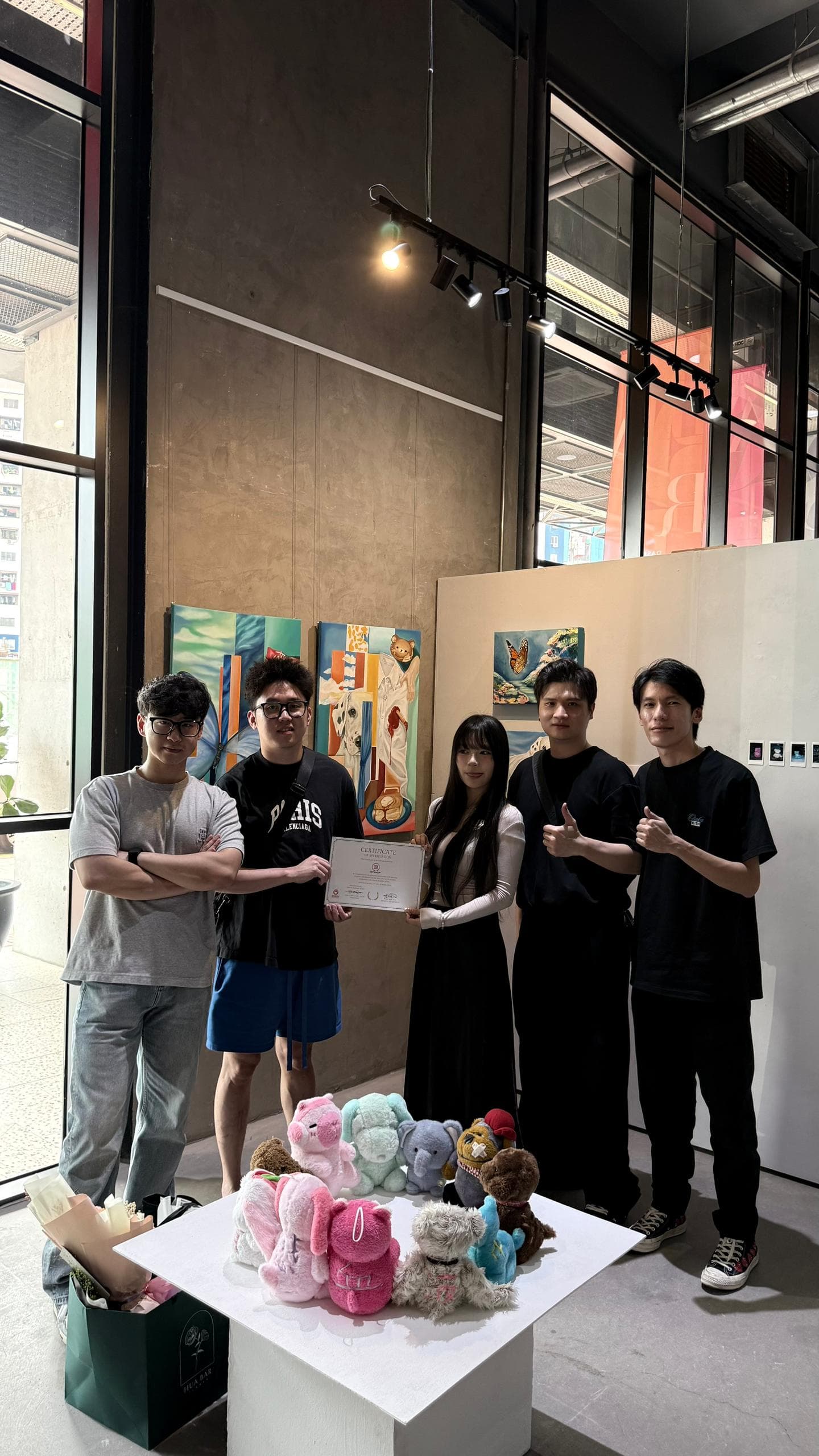 CSY Group representatives with an exhibition artist holding a certificate