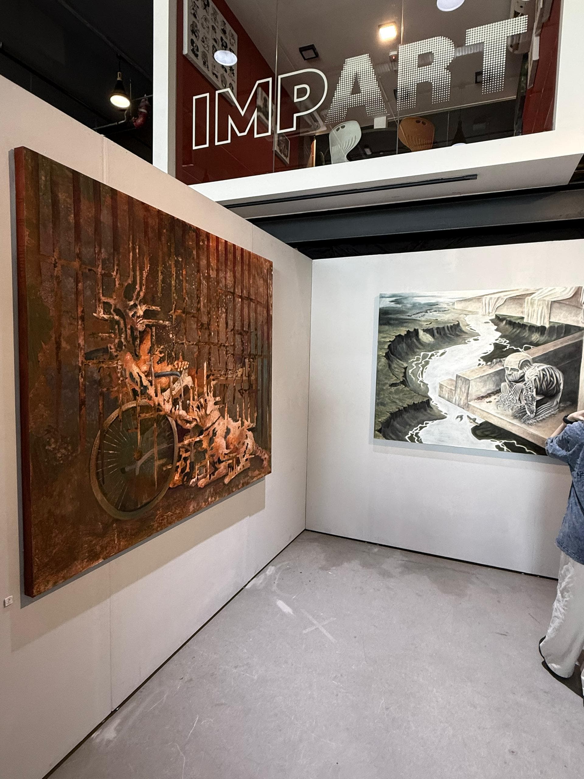 Paintings shown below the IMPART sign at Dasein Academy of Art